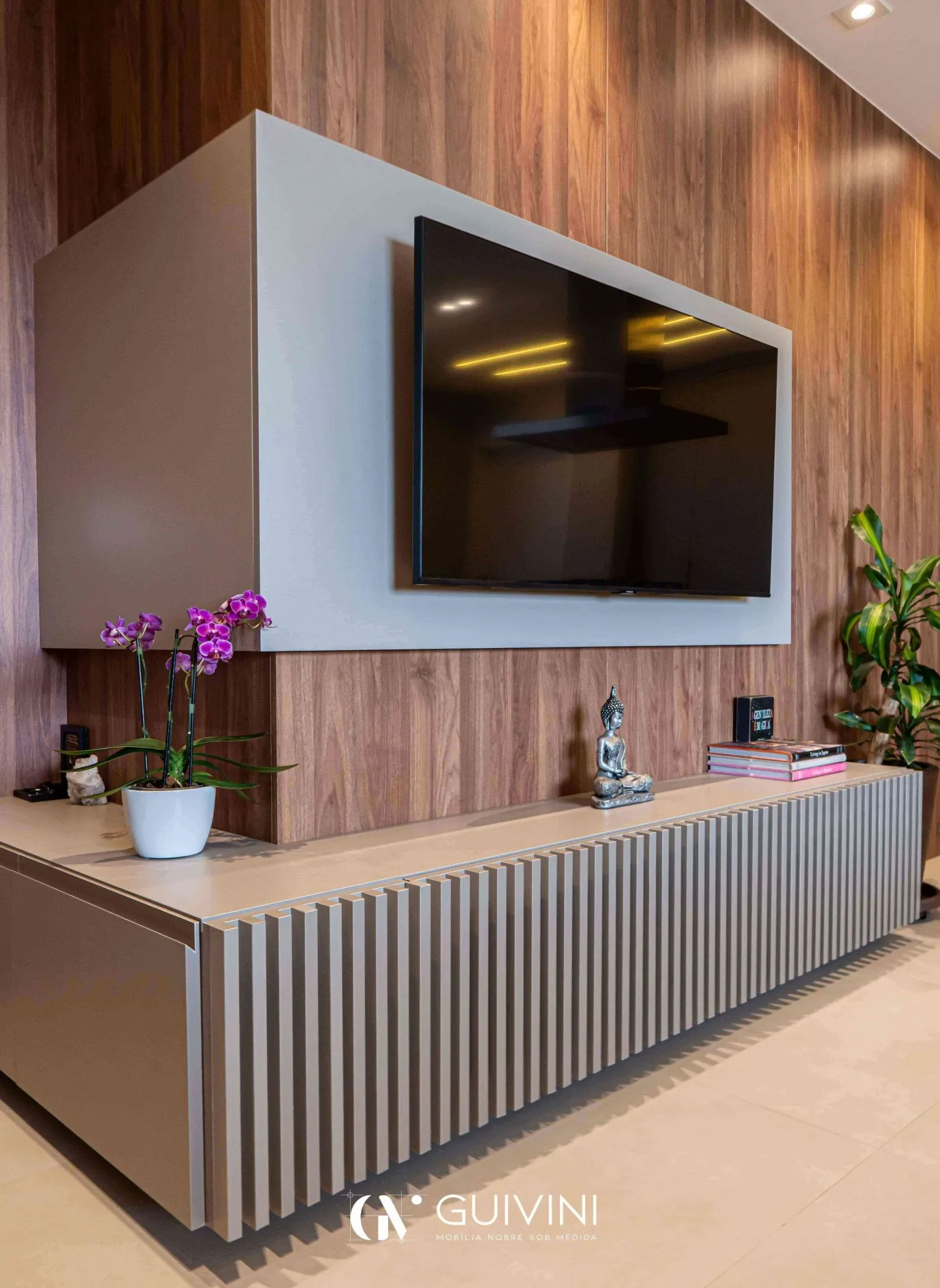 Imagem de uma copa com bancada de madeira, taças,
                          talheres, geladeira de inox e armário em cinza